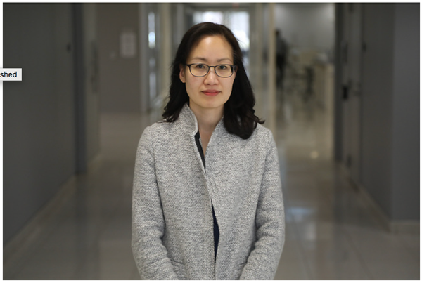 A person wearing glasses and a grey coat

AI-generated content may be incorrect.