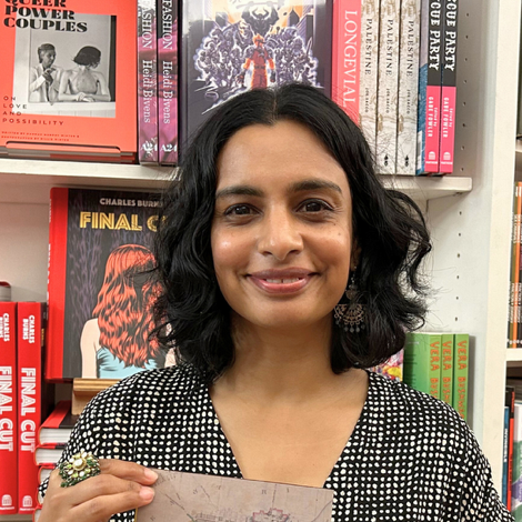 A person holding a card in front of a book shelf

AI-generated content may be incorrect.